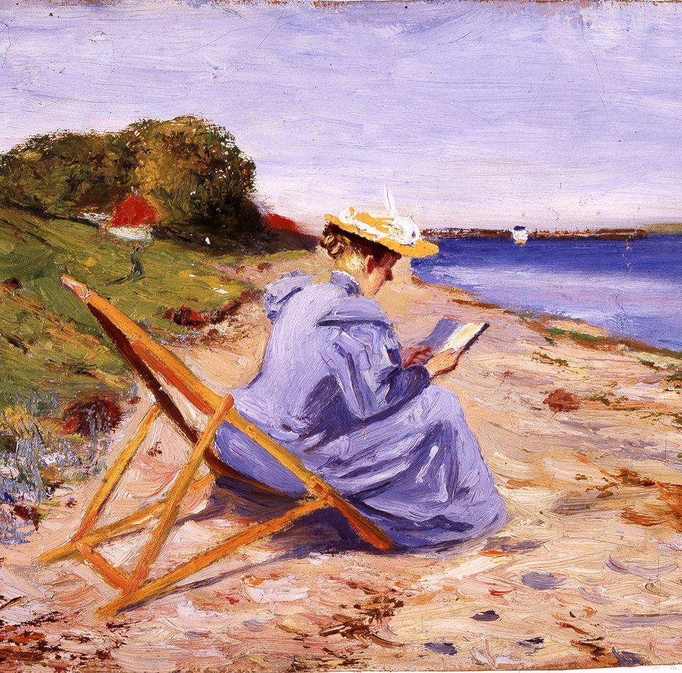 Eine Frau sitzt in einem Liegestuhl und trägt ein blaues Kleid mit einem Strohhut. Sie ist vorgebeugt und liest ein Buch. Hinter ihr sieht man den Strand und das Meer mit einem Boot. Links ist eine Wiese mit einem Haus und Bäumen.